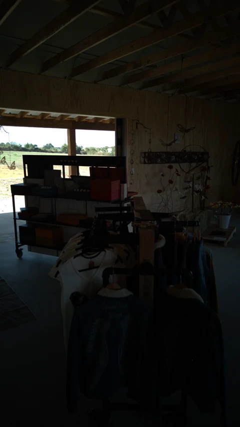 Clothing displayed on wooden racks inside The Hive