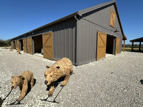 Carved wooden bears displayed outside The Hive