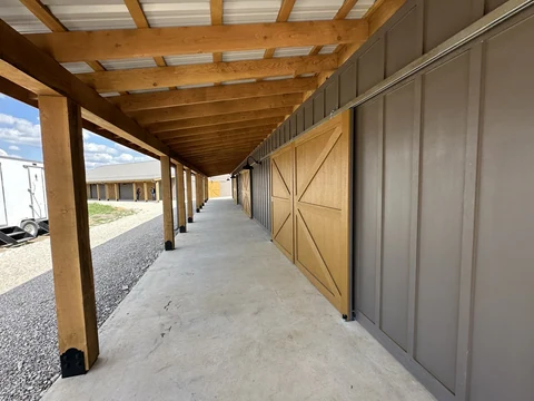 Long covered porch and wooden barn doors at The Hive
