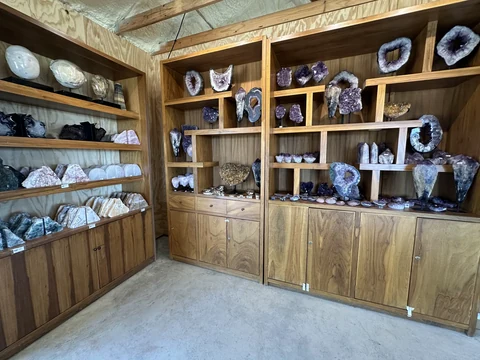 Shelves lined with geodes, crystals, and mineral specimens