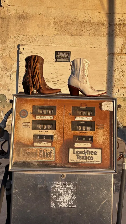 Boots beside a vintage gas pump
