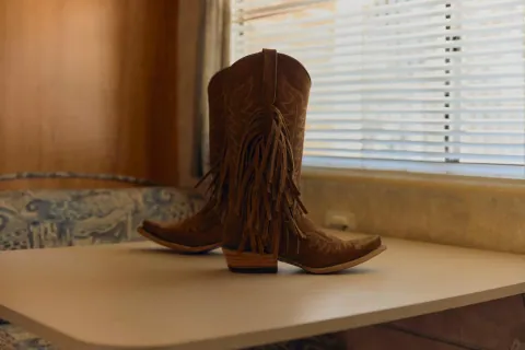 Fringed boots on a diner table